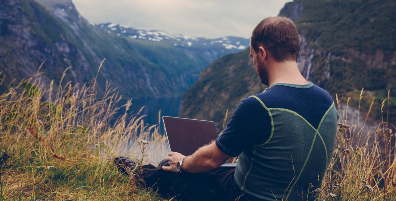 Man Staring at Blank Computer in the Mountains